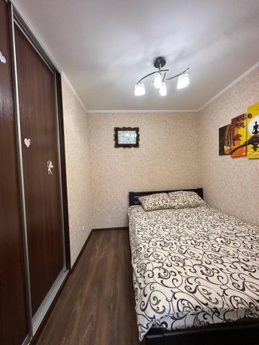 a bedroom with a bed and a sliding door at Central Comfort in Konotop