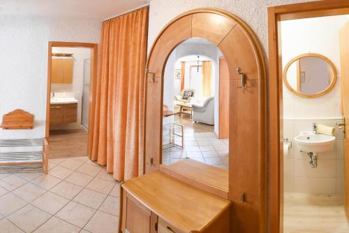 a bathroom with a mirror and a sink in it at Am Sonnenhang inkl. Chiemgaukarte in Ruhpolding