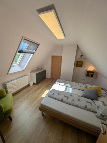 a attic bedroom with a bed and a skylight at Ferienhaus Grabenhansl in Stubenberg