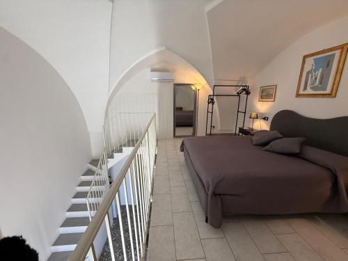 a bedroom with a bed next to a staircase at Aquarius Salento in Acquarica del Capo