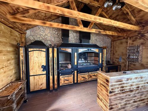 a room with wooden walls and a large entry door at Koliba Buba in Brčko