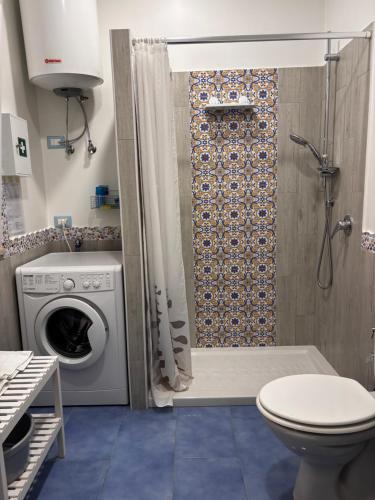 a bathroom with a shower and a washing machine at Vacanze a 2 passi dal mare in Giardini Naxos