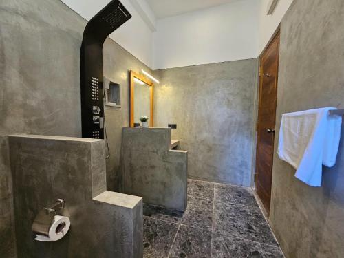 a bathroom with a sink and a toilet in it at The Blacksmith Villa in Habaraduwa Central