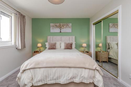 a bedroom with a large bed and two windows at Seaview Bed & Breakfast in Isle of Lewis
