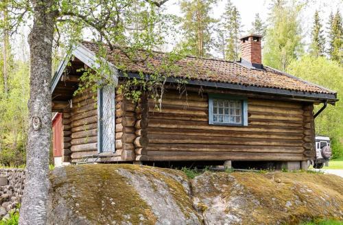 a log cabin with a window on top of a rock at Midsommar Stuga in Årjäng