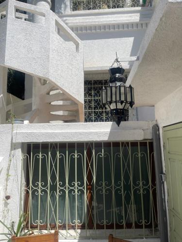 a gate on a building with a staircase and a light at Syrah Home in Tangier