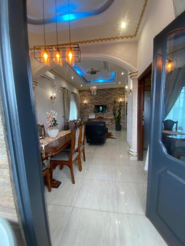 a dining room and living room with a table at La Bienveillance in Brazzaville