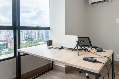 an office with a desk with a laptop on it at Full Apartment with Pool and Gym - M1605 in Recife