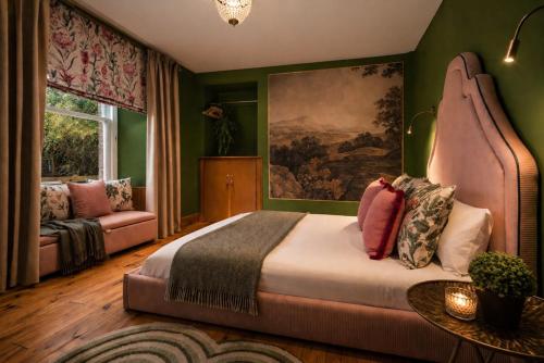 a bedroom with a bed and a painting on the wall at Wonderland Berwick 5-bedrooms Pet-friendly cottage with the Hot tub in Tweedmouth