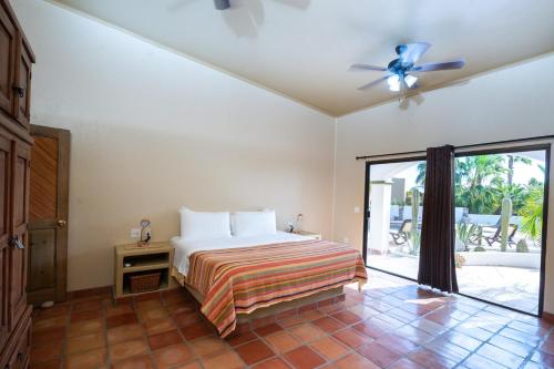 a bedroom with a bed and a ceiling fan at Pool Oasis Close to the Beach and Pickleball in Las Palmas