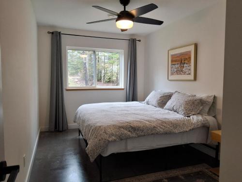 a bedroom with a bed with a ceiling fan at Fernie Alpine Retreat in Fernie