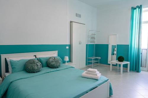 a blue and white bedroom with a large bed at Palazzo Ambrosio in Nola