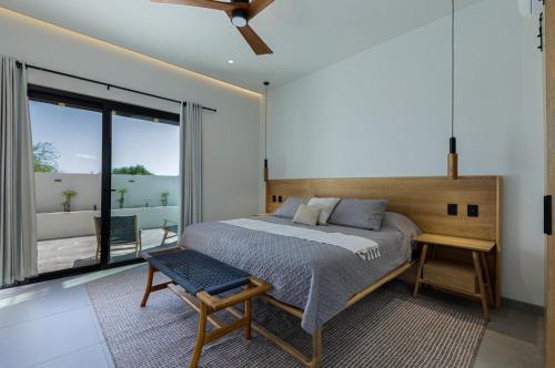 a bedroom with a large bed and a balcony at Luxury Villa With Pool in Los Barriles