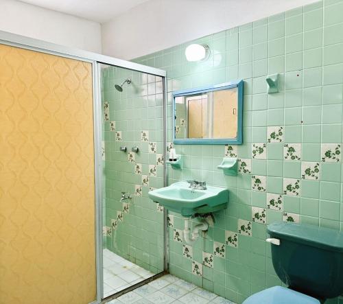 a bathroom with a toilet and a sink and a shower at Casona Tulish, Campeche in Campeche