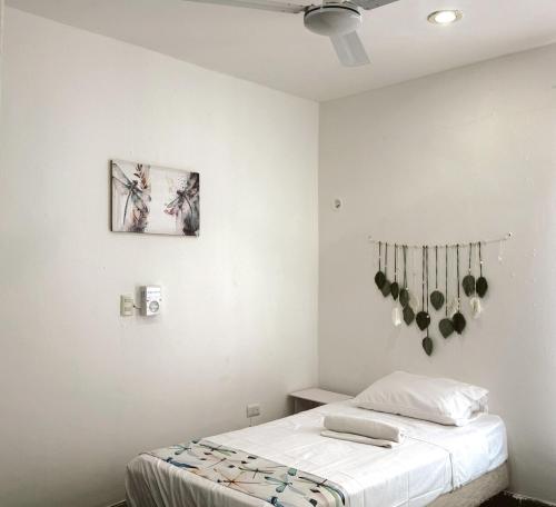 a white bedroom with a bed and a ceiling at Casona Tulish, Campeche in Campeche