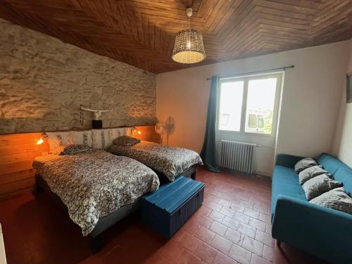 a bedroom with two beds and a couch at Maison avec piscine et vue panoramique in Albi