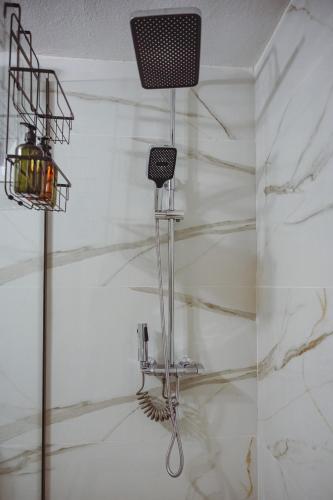 a room with a white marble wall with a microphone at Datidis Urban Nest in Komotini