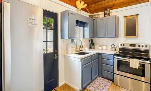 a blue kitchen with a sink and a stove at The Rubber Duck in Gravois Mills