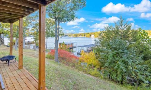 a wooden porch with a view of the water at Amber Waters Hideaway in Camdenton