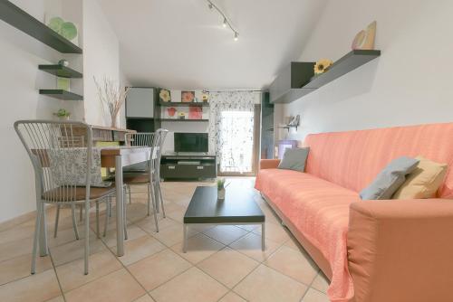 a living room with a couch and a table at Queen Home Funo Centergross in Castel Maggiore