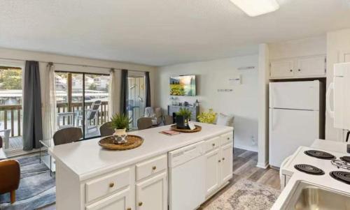 a kitchen with a large white island in a room at The Luxe Lakefront in Lake Ozark