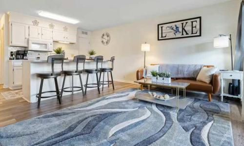 a living room with a couch and a table at The Luxe Lakefront in Lake Ozark