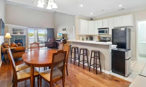 a kitchen and living room with a table and chairs at Lakeside Lookout in Sunrise Beach
