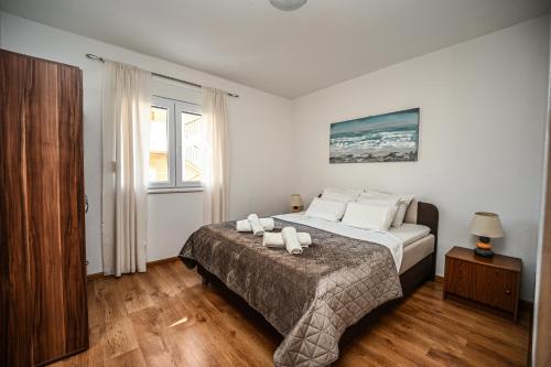 a bedroom with a large bed with white pillows at Mikuljan Apartments with Pool-5 min to Beach & Private Parking Included in Stobreč