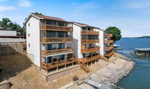 an apartment building with balconies next to the water at Lake Front Lookout in Lake Ozark