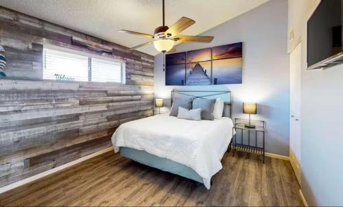 a bedroom with a reclaimed wood accent wall at Southwood Serenity in Lake Ozark
