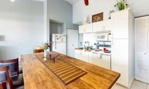a kitchen with a wooden table and a refrigerator at Southwood Serenity in Lake Ozark