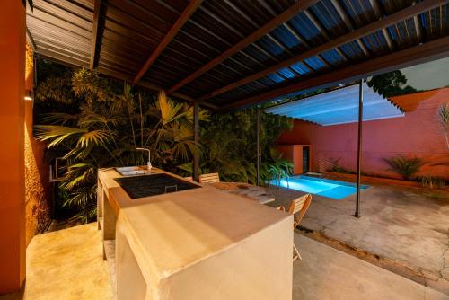 a patio with a pool in the back of a house at Casa Penta Top Notch Villa in Medellín