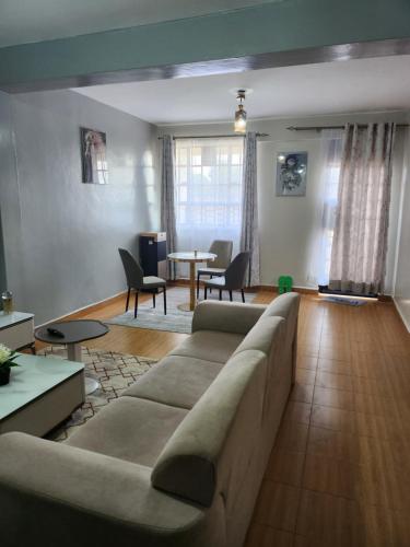 a living room with a couch and a table at Zariah Homes 1 in Kakamega