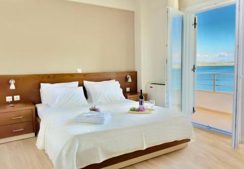 a bedroom with a bed with a view of the ocean at Sea Sparkle 1a in Preveza