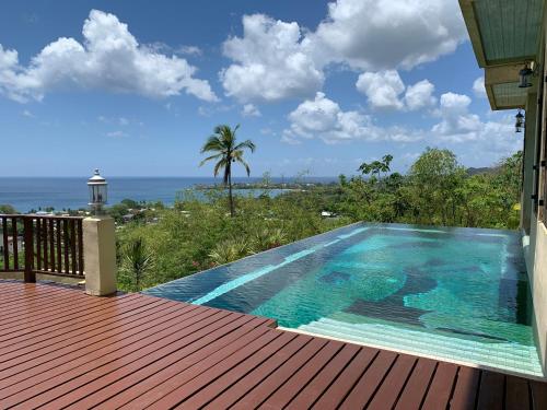a swimming pool on the deck of a house at Villa Azulejo in Black Rock