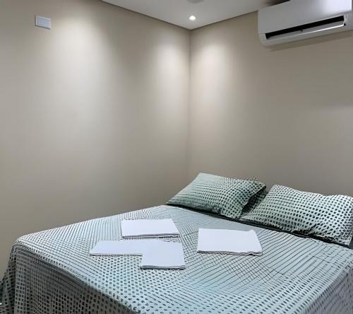 a bedroom with a bed with two numbers on it at Madonna Prime Studio Hotel Extrema MG + breakfast in Extrema
