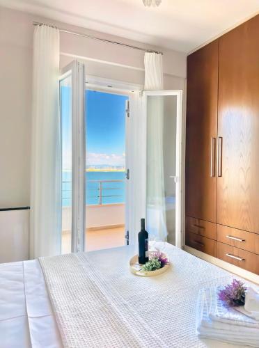 a bedroom with a bed with a view of the ocean at Sea Sparkle 1b in Preveza