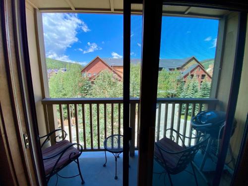 a balcony with two chairs and a view out the window at Red Hawk Lodge 2297 by SummitCove Lodging in Colorado in Keystone