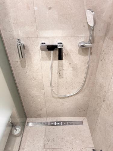 a shower with a shower head in a bathroom at NV Apartments 2 in Volodymyr-Volynskyi