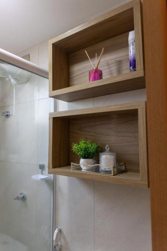 a bathroom with a wooden cabinet with a shower at Studio premium aconchegante vista mar in São Luís