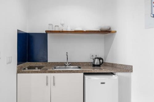 a kitchen with a sink and a counter top at Art Hotel in Kralendijk