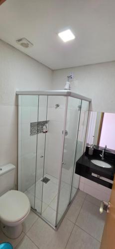 a bathroom with a shower and a toilet and a sink at Paris Flats Lagoa Santa in Lagoa Santa