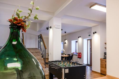 a room with a glass vase and a chess board at Apartmaji Tinta in Kanal