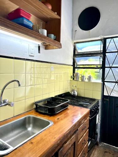 a kitchen with a sink and a stove at La Escondida de Tigre in Tigre