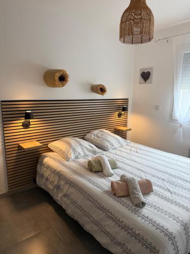 a bedroom with a large bed with two towels on it at Gites de la Casasole in Vogüé