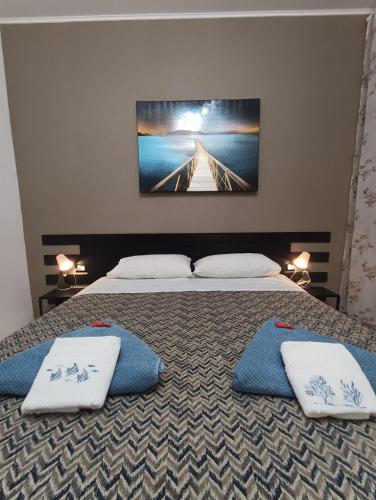 a bedroom with two beds with pillows and a tv on the wall at Rolando 20B in Genoa