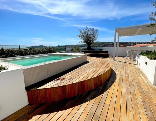 a wooden deck with a swimming pool on top of a house at Like at Home - Boutique A6 Sea view, Private Terrace & Pool in Palau