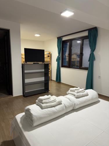 a bedroom with a bed with four towels on it at Къща за гости Бели Осъм in Beli Osŭm