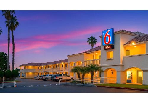 a hotel with a sign in a parking lot at Motel 6-Carlsbad, CA Beach in Carlsbad