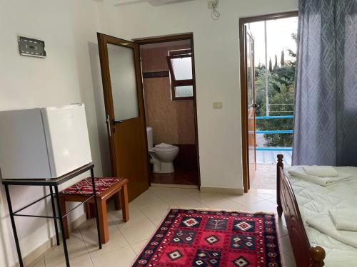 a room with a bed and a bathroom with a toilet at Olive Nest Bunec in Sasaj